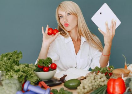 Vlogger promoting healthy eating with fresh vegetables on the table.